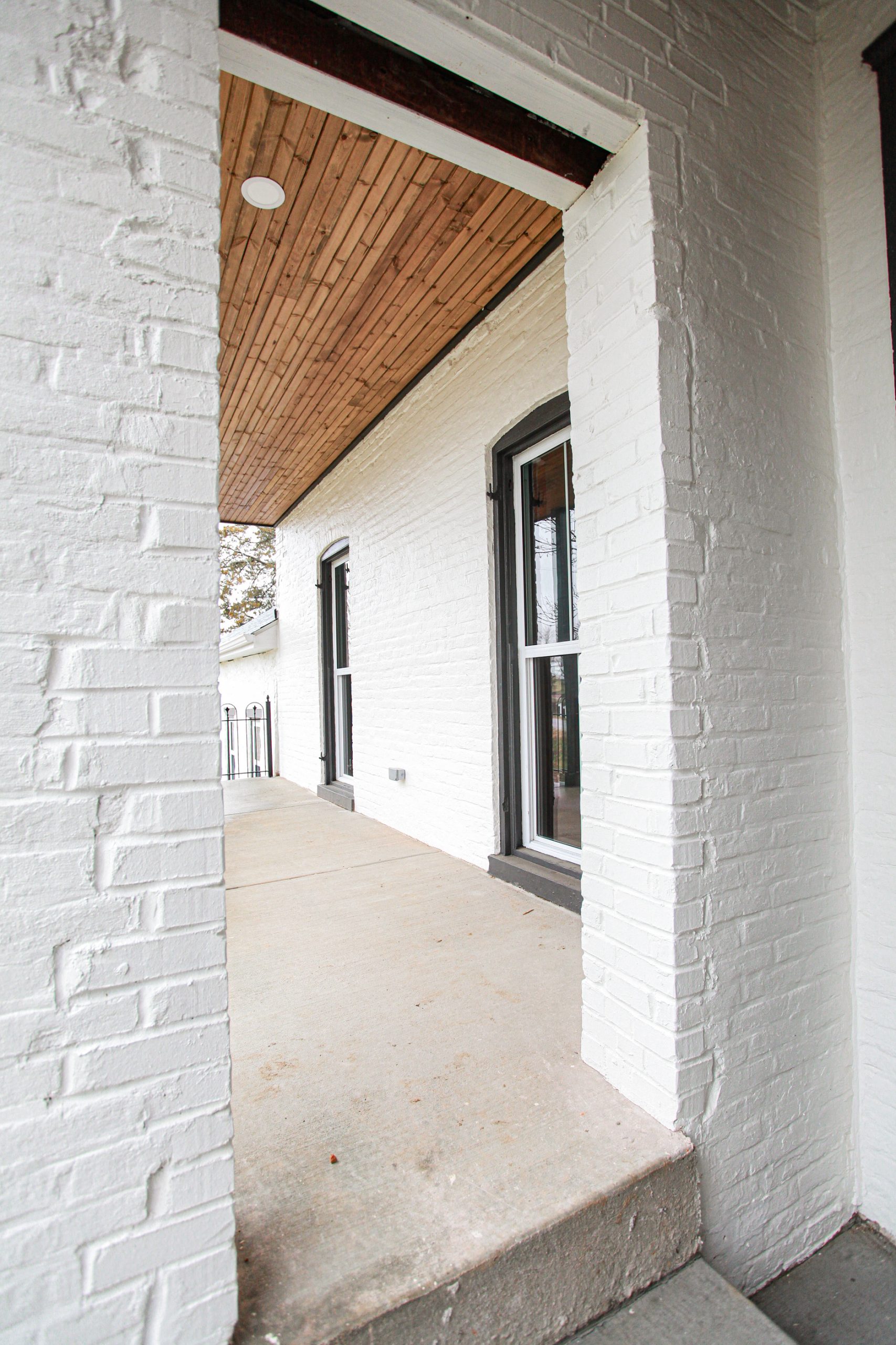 Architectural detail showing refined porch columns, trim, and brickwork