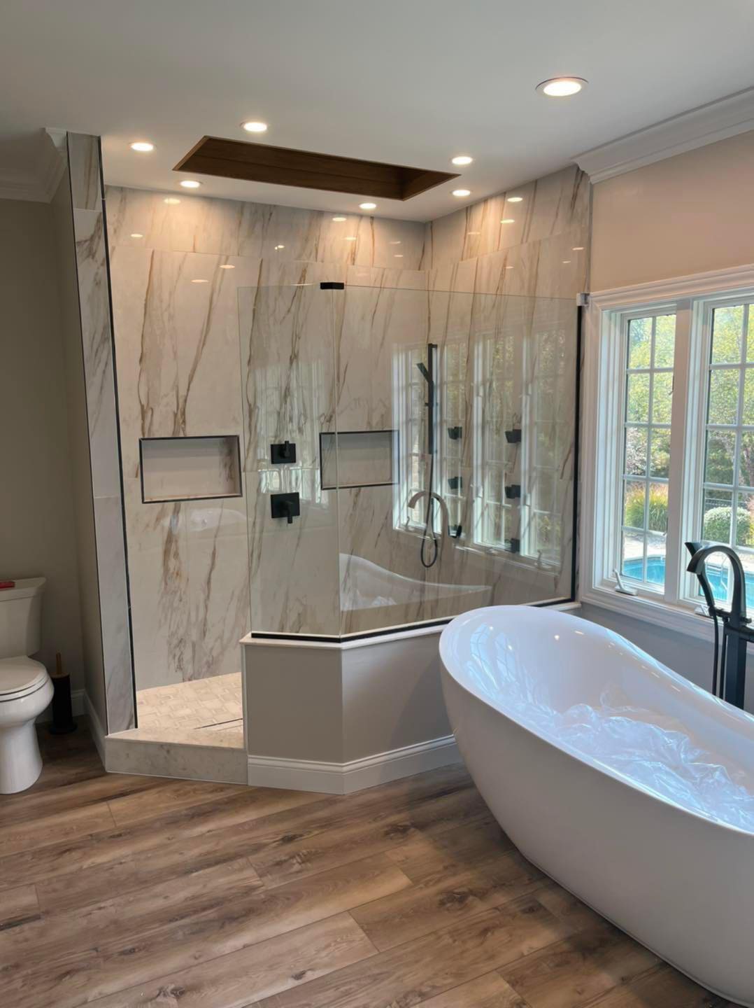 Bath detail with stone walls and freestanding tub