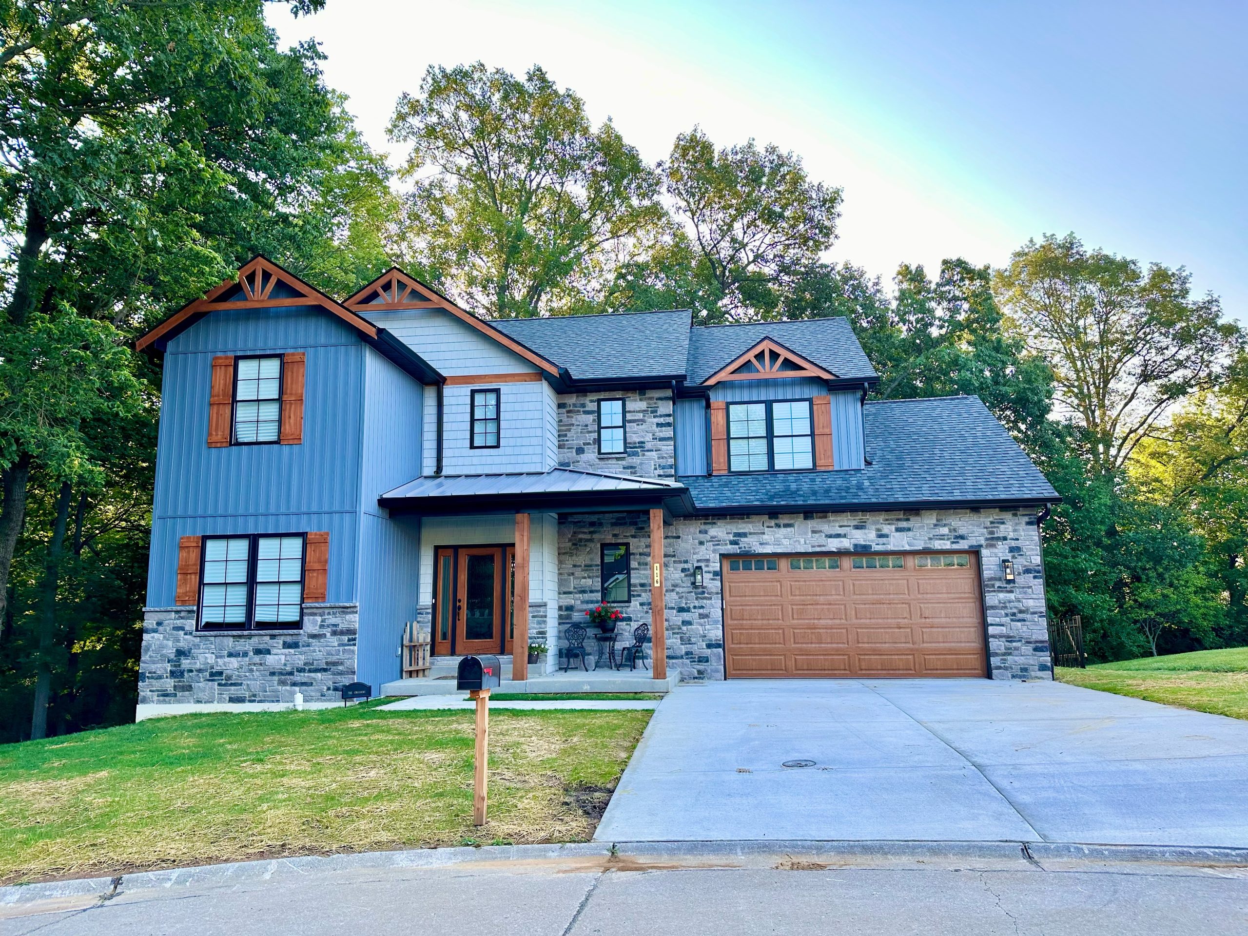 Completed Timberline custom home exterior with stone and covered porch